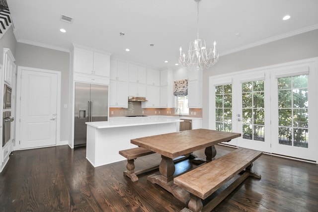 206 Green Blvd, Shenandoah, TX 77384 - dining area with dark wood finished floors, a chandelier, recessed lighting, and ornamental molding