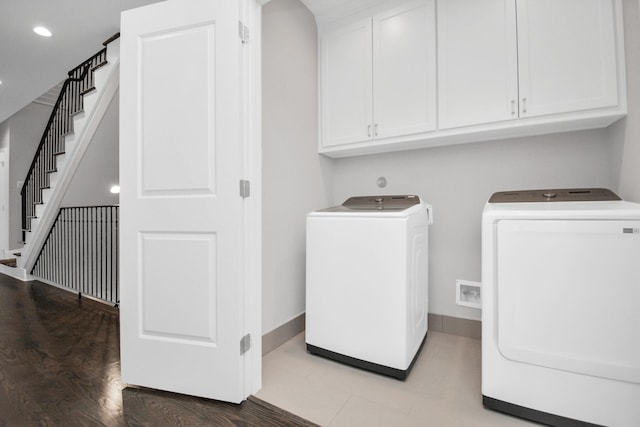 206 Green Blvd, Shenandoah, TX 77384 - laundry room with separate washer and dryer, cabinet space, recessed lighting, and wood finished floors