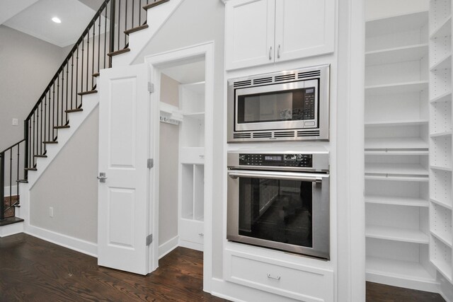 206 Green Blvd, Shenandoah, TX 77384 - kitchen with stainless steel appliances, dark wood-style floors, white cabinets, and recessed lighting