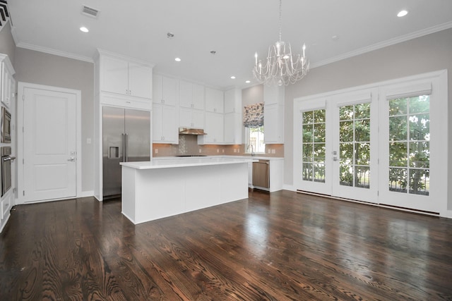 206 Green Blvd, Shenandoah, TX 77384 - kitchen featuring built in appliances, a center island, light countertops, a chandelier, and white cabinetry