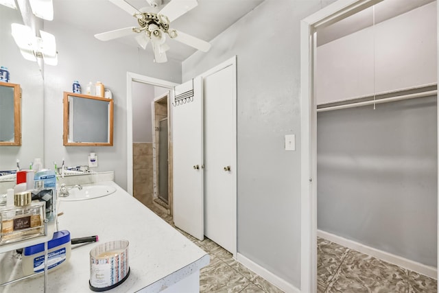 10806 Sagegulf Ln, Houston, TX 77089 - bathroom featuring vanity, ceiling fan, a walk in closet, and a shower with shower door