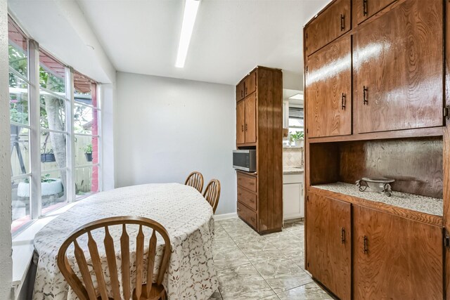 10806 Sagegulf Ln, Houston, TX 77089 - kitchen featuring stainless steel microwave and brown cabinets