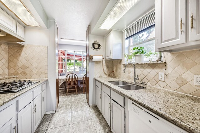 10806 Sagegulf Ln, Houston, TX 77089 - kitchen with dishwasher, gas cooktop, white cabinets, and decorative backsplash