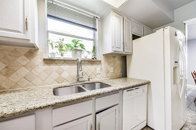 10806 Sagegulf Ln, Houston, TX 77089 - kitchen with white appliances, decorative backsplash, white cabinets, and light stone counters