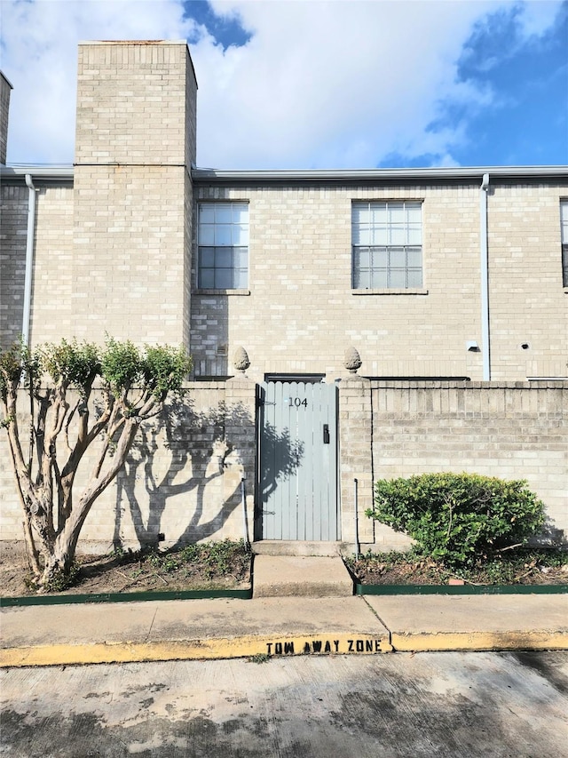 6500 Sands Point Dr Unit 104, Houston, TX 77074 - view of front of home with brick siding and a chimney