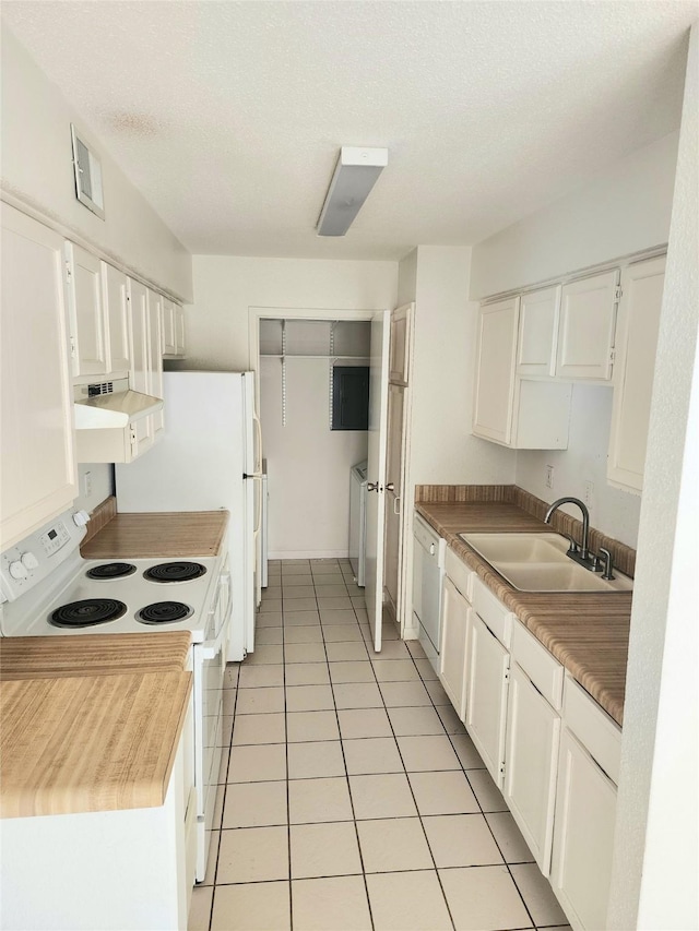 6500 Sands Point Dr Unit 104, Houston, TX 77074 - kitchen with white appliances, custom exhaust hood, separate washer and dryer, white cabinets, and light tile patterned floors