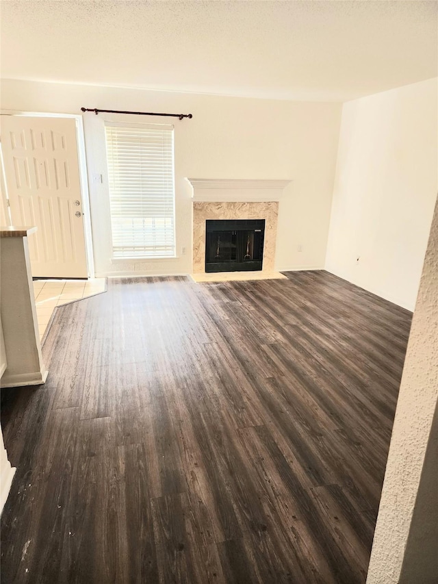 6500 Sands Point Dr Unit 104, Houston, TX 77074 - unfurnished living room featuring wood finished floors and a high end fireplace
