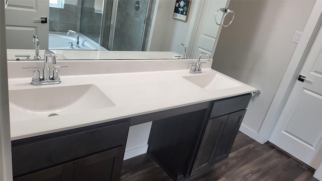 21319 Indigo Ruth Dr, Spring, TX 77379 - full bathroom featuring a stall shower, double vanity, a garden tub, and wood finished floors