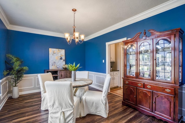 20919 Autumn Redwood Way, Cypress, TX 77433 - dining space with a chandelier, ornamental molding, dark wood-type flooring, a decorative wall, and a wainscoted wall