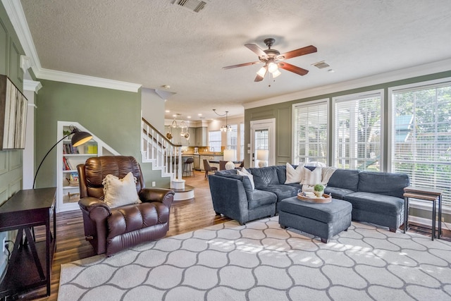 20919 Autumn Redwood Way, Cypress, TX 77433 - living area with wood finished floors, a ceiling fan, stairway, ornamental molding, and a textured ceiling