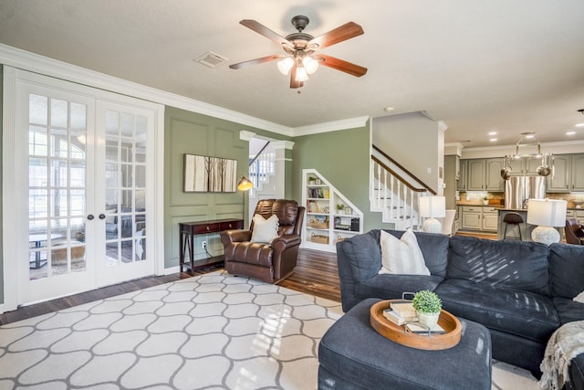 20919 Autumn Redwood Way, Cypress, TX 77433 - living area featuring wood finished floors, stairway, french doors, ceiling fan, and ornamental molding