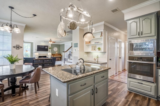 20919 Autumn Redwood Way, Cypress, TX 77433 - kitchen featuring appliances with stainless steel finishes, dark wood finished floors, gray cabinets, a kitchen island, and a textured ceiling