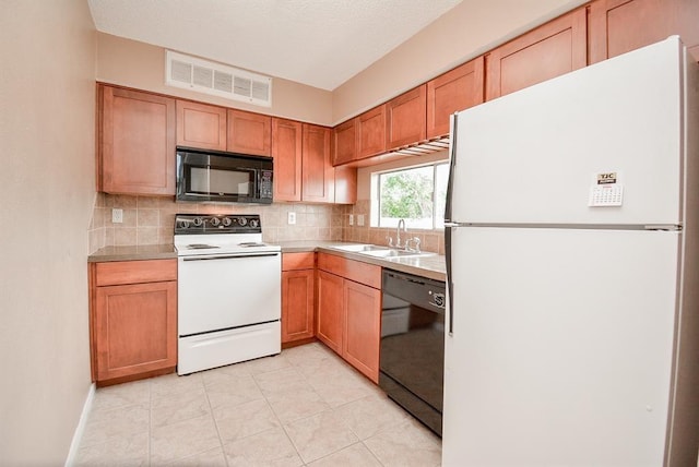 10855 Meadowglen Ln Unit 721, Houston, TX 77042 - kitchen with black appliances, tasteful backsplash, light countertops, light tile patterned flooring, and brown cabinetry