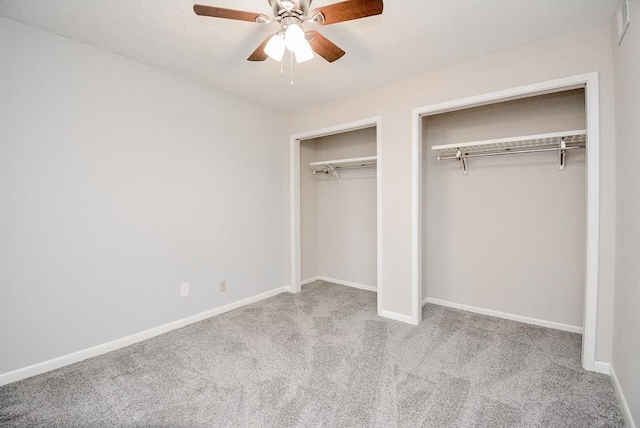 10855 Meadowglen Ln Unit 721, Houston, TX 77042 - unfurnished bedroom featuring multiple closets, carpet flooring, and a ceiling fan