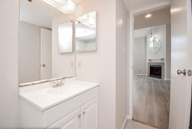 10855 Meadowglen Ln Unit 721, Houston, TX 77042 - bathroom featuring vanity, a fireplace, and recessed lighting