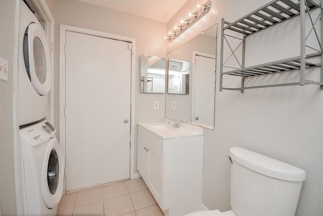 10855 Meadowglen Ln Unit 721, Houston, TX 77042 - half bathroom featuring stacked washer / drying machine, vanity, and tile patterned floors