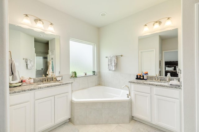 2337 Shalmar Dr, West Columbia, TX 77486 - full bath featuring two vanities, a garden tub, tile patterned floors, and ensuite bath