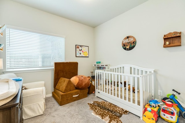 2337 Shalmar Dr, West Columbia, TX 77486 - carpeted bedroom featuring a crib and baseboards