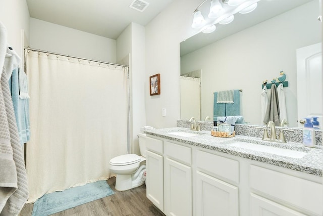 2337 Shalmar Dr, West Columbia, TX 77486 - full bathroom with wood finished floors, double vanity, and a chandelier