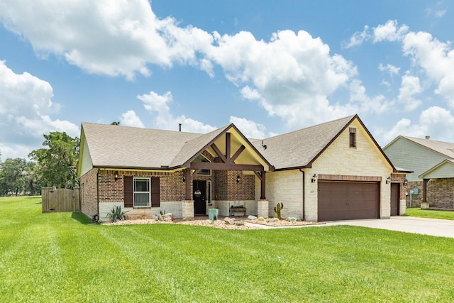 2337 Shalmar Dr, West Columbia, TX 77486 - english style home featuring an attached garage, a shingled roof, concrete driveway, brick siding, and stone siding