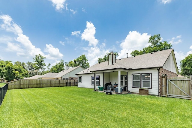 2337 Shalmar Dr, West Columbia, TX 77486 - back of property with a fenced backyard, a chimney, and a gate