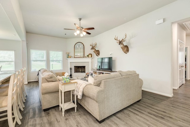 2337 Shalmar Dr, West Columbia, TX 77486 - living area with wood finished floors, a ceiling fan, and a fireplace