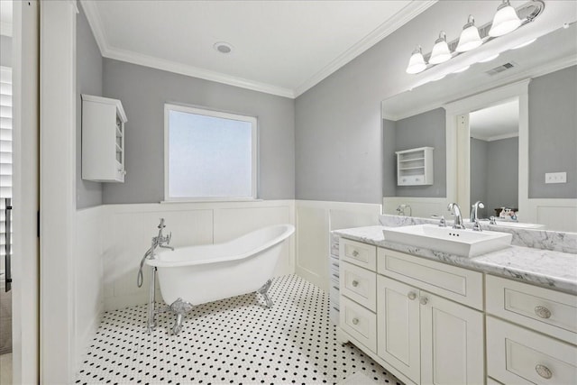 5219 Camp Creek Rd, Baytown, TX 77523 - full bathroom featuring wainscoting, a soaking tub, vanity, and ornamental molding