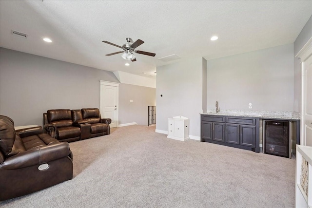5219 Camp Creek Rd, Baytown, TX 77523 - carpeted living room featuring beverage cooler, wet bar, ceiling fan, and recessed lighting