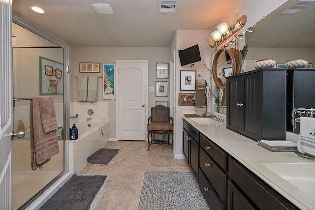 12207 Green City Ln, Houston, TX 77047 - bathroom featuring a bath, double vanity, tile patterned flooring, and recessed lighting