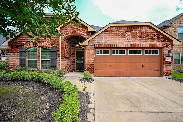 12207 Green City Ln, Houston, TX 77047 - view of front of property with brick siding, a garage, and concrete driveway