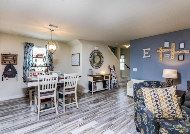 25706 Provender Pl, Katy, TX 77493 - dining area with stairs, wood finished floors, plenty of natural light, and a chandelier
