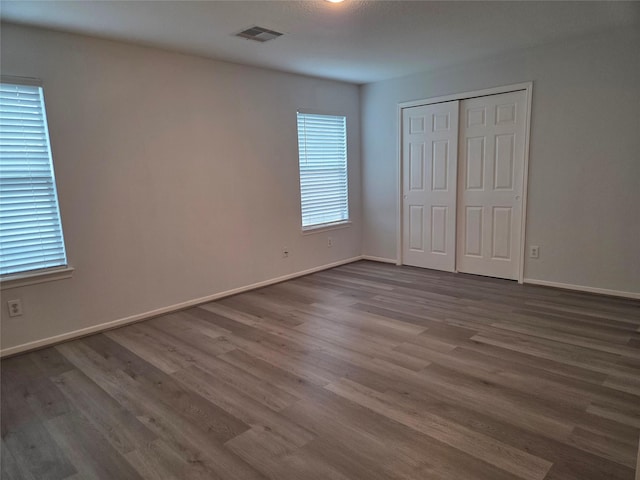 2703 Oakland Brook St, Houston, TX 77038 - unfurnished bedroom featuring dark wood finished floors and a closet
