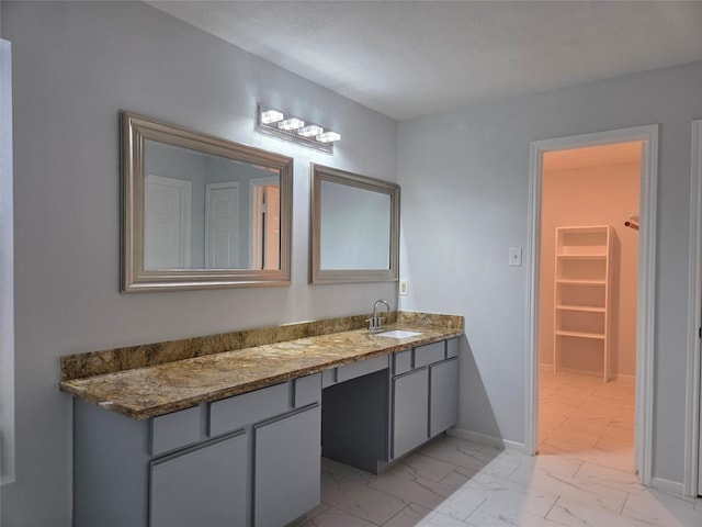 2703 Oakland Brook St, Houston, TX 77038 - bathroom featuring marble finish flooring, vanity, and a spacious closet