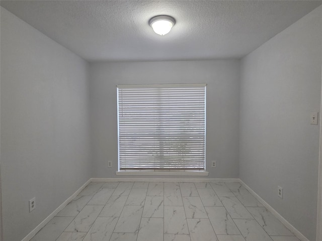 2703 Oakland Brook St, Houston, TX 77038 - unfurnished room with light marble finish floors and a textured ceiling