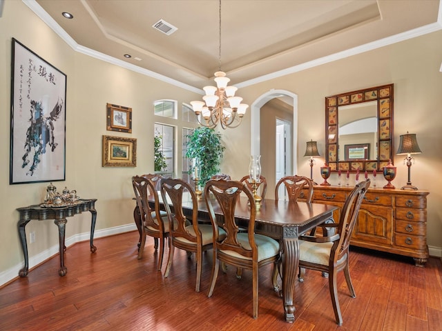 6922 Carolina Cherry Ln, Spring, TX 77389 - dining area with a raised ceiling, hardwood / wood-style flooring, arched walkways, recessed lighting, and ornamental molding