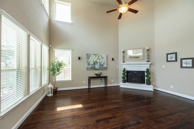 27619 Dalton Bluff Ct, Katy, TX 77494 - living room featuring a towering ceiling, a ceiling fan, wood finished floors, and a fireplace