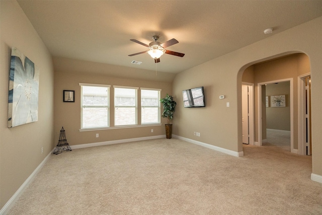 27619 Dalton Bluff Ct, Katy, TX 77494 - spare room with arched walkways, a ceiling fan, a smoke detector, and light colored carpet