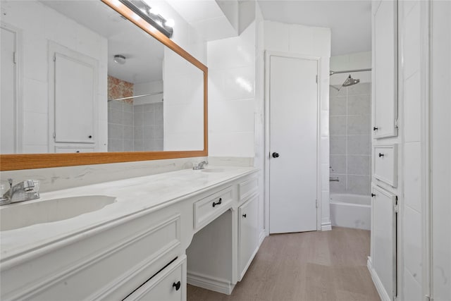 11011 Bandlon Dr, Houston, TX 77072 - full bathroom with double vanity, wood finished floors, and shower / tub combination