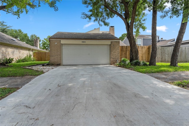 11011 Bandlon Dr, Houston, TX 77072 - view of front of property with brick siding, driveway, a chimney, and a garage