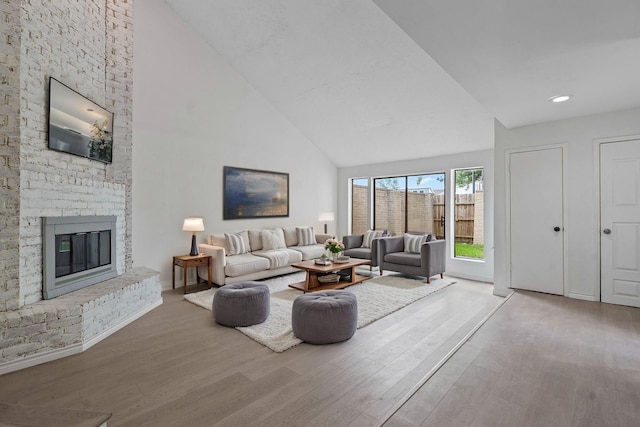11011 Bandlon Dr, Houston, TX 77072 - living room with high vaulted ceiling, wood finished floors, a brick fireplace, and recessed lighting