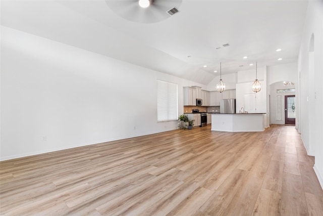 9427 Harmony Lake Ln, Richmond, TX 77469 - unfurnished living room featuring a ceiling fan, light wood-type flooring, recessed lighting, a chandelier, and high vaulted ceiling