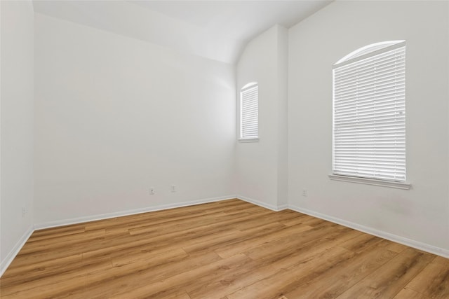 9427 Harmony Lake Ln, Richmond, TX 77469 - spare room featuring lofted ceiling and light wood-style floors