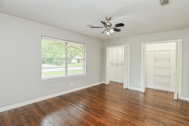4502 Sanford Rd, Houston, TX 77035 - unfurnished bedroom featuring dark wood-type flooring, multiple closets, and ceiling fan