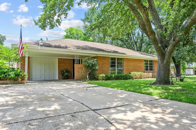 4502 Sanford Rd, Houston, TX 77035 - ranch-style home with brick siding, a carport, concrete driveway, a garage, and a front lawn