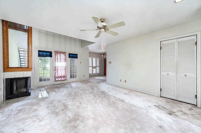 16160 Seahorse Dr, Houston, TX 77062 - unfurnished living room featuring a multi sided fireplace, ceiling fan, carpet flooring, and a chandelier