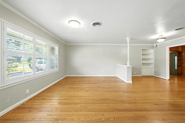 3014 Castlewood St, Houston, TX 77025 - unfurnished room featuring crown molding, built in features, and light wood-style floors