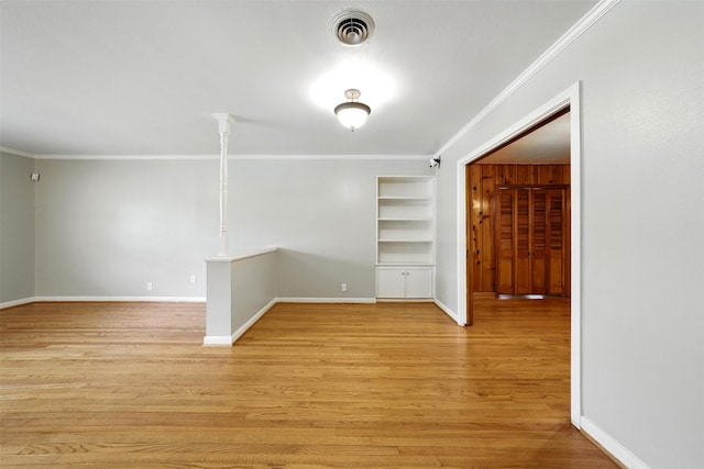 3014 Castlewood St, Houston, TX 77025 - empty room featuring built in shelves, ornamental molding, and light wood-style flooring