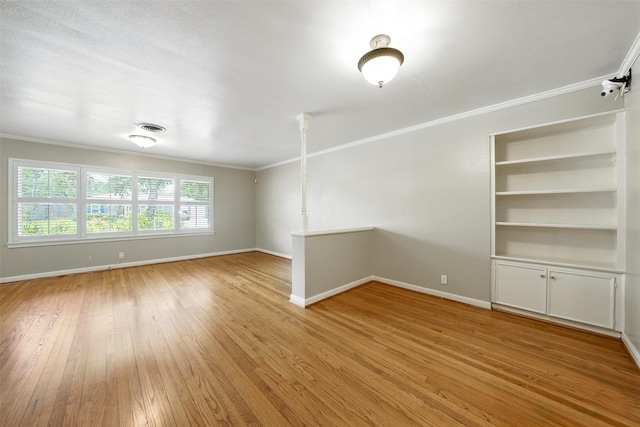 3014 Castlewood St, Houston, TX 77025 - empty room featuring crown molding, light wood-style floors, and built in shelves