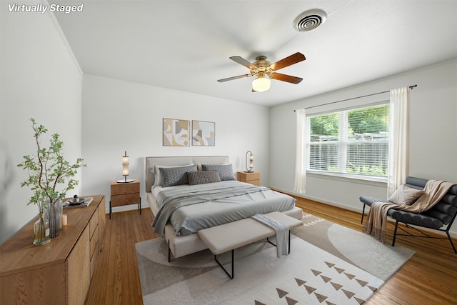 3014 Castlewood St, Houston, TX 77025 - bedroom with light wood-style flooring and a ceiling fan
