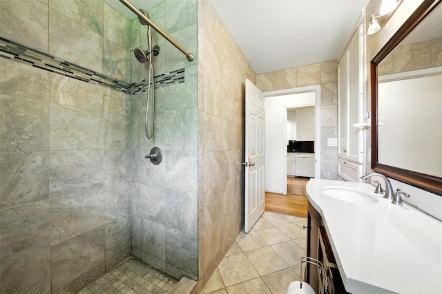 3014 Castlewood St, Houston, TX 77025 - full bath with a tile shower, vanity, tile patterned floors, and tile walls